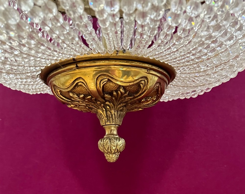 A French Empire style crystal basket chandelier featuring cascading glass bead strands and a chased gilt-bronze ornamental ring. View IV