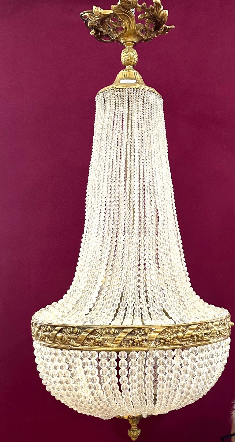A French Empire style crystal basket chandelier featuring cascading glass bead strands and a chased gilt-bronze ornamental ring. View V