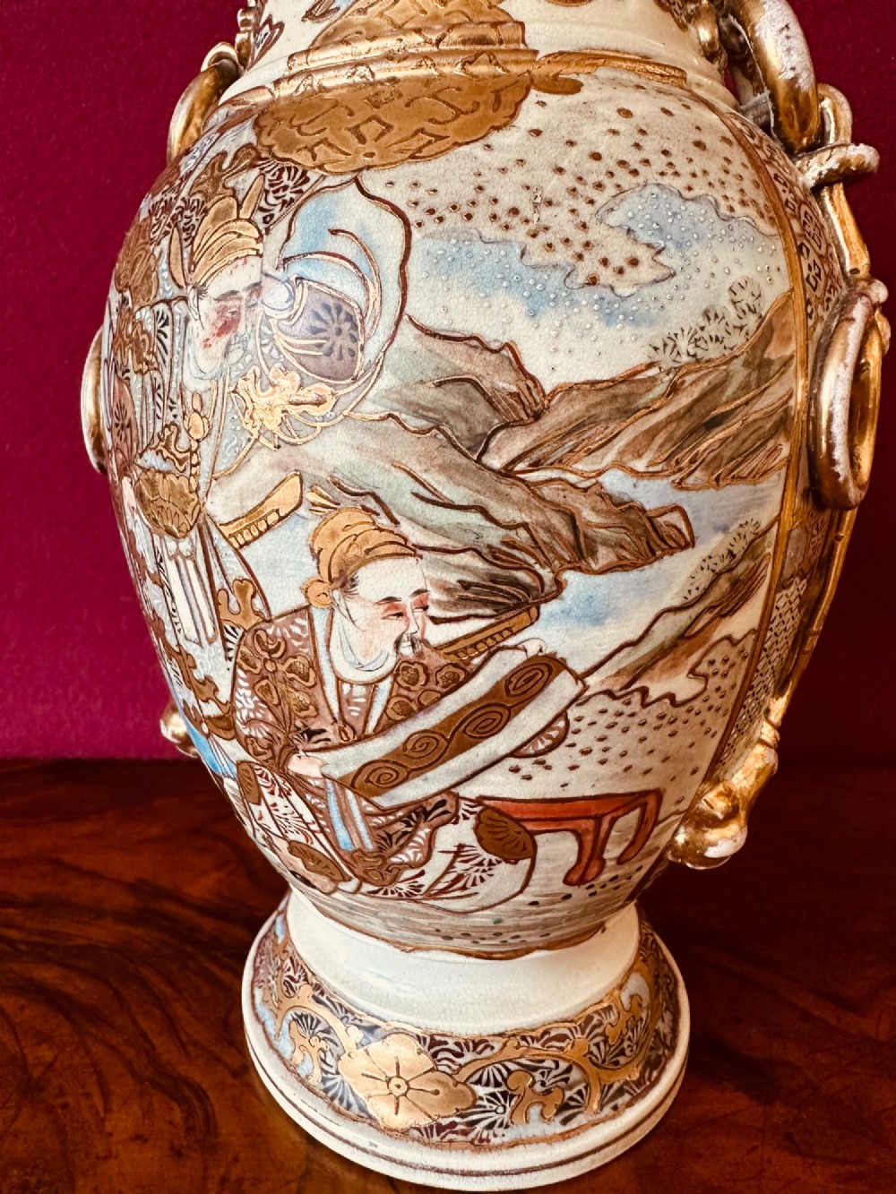 A Japanese Satsuma earthenware vase with crackle glaze, detailed polychrome figures, and heavy gold enamelling. View VI