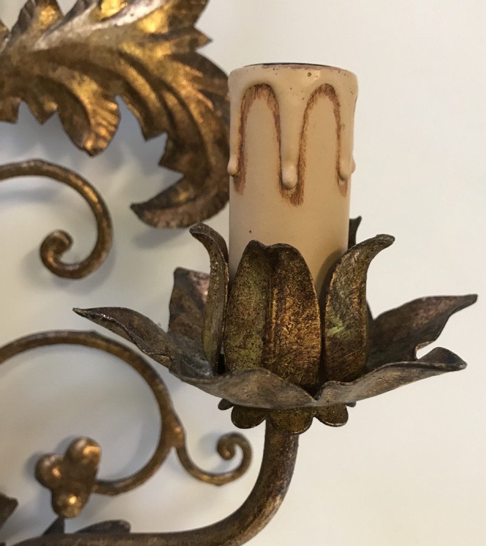 A pair of large French gilt metal three-light wall sconces with elaborate scrollwork and acanthus leaf details. View IV