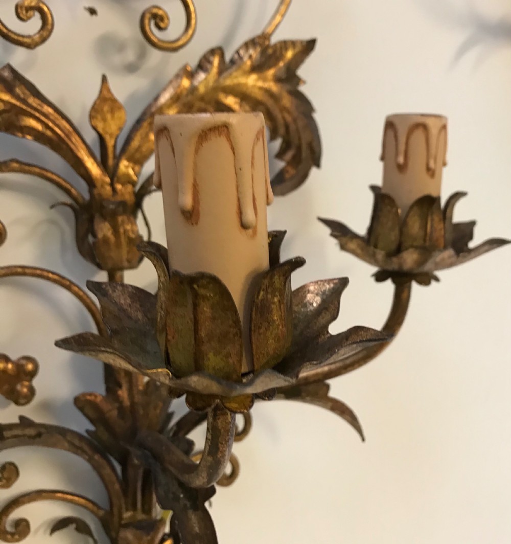 A pair of large French gilt metal three-light wall sconces with elaborate scrollwork and acanthus leaf details. View VII