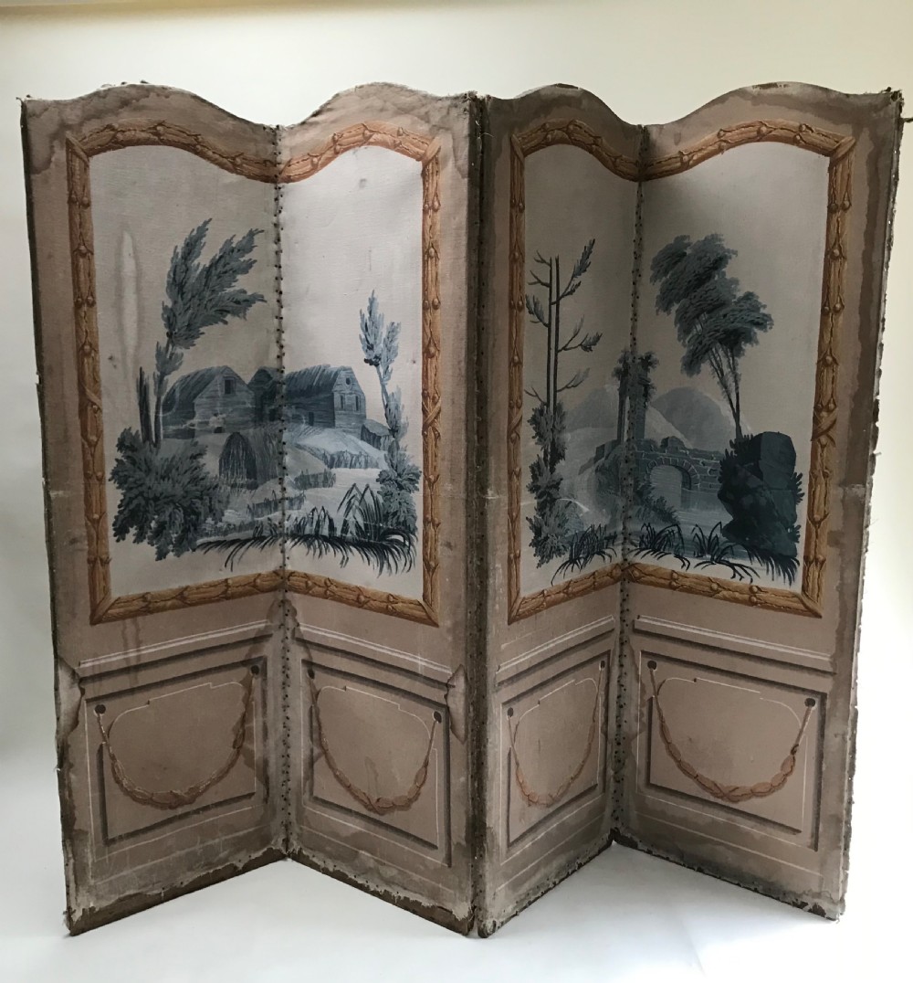 A four-panel French folding screen featuring hand-painted monochrome landscape scenes above simulated wooden wall panelling.