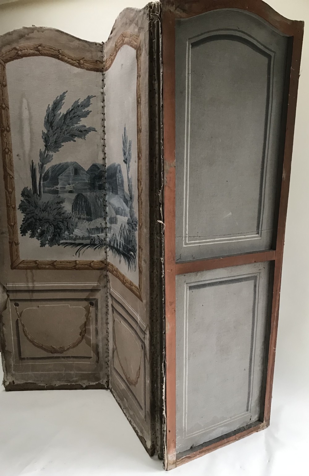 A four-panel French folding screen featuring hand-painted monochrome landscape scenes above simulated wooden wall panelling. View VII