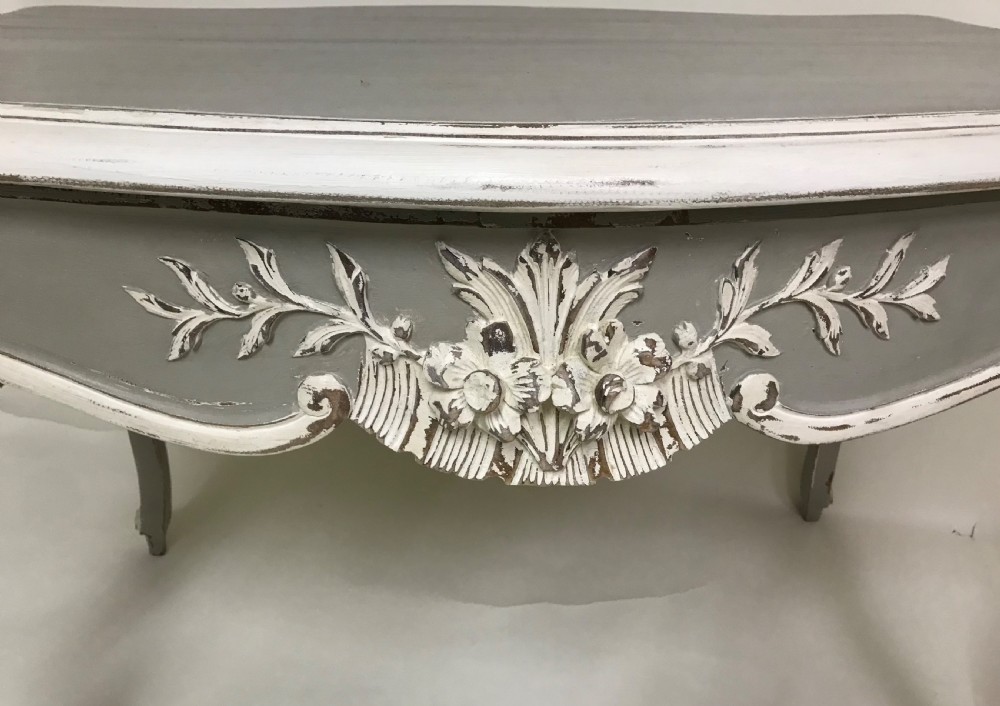 A grey painted French Rococo style side table featuring carved white foliate accents and slender cabriole legs. View VI