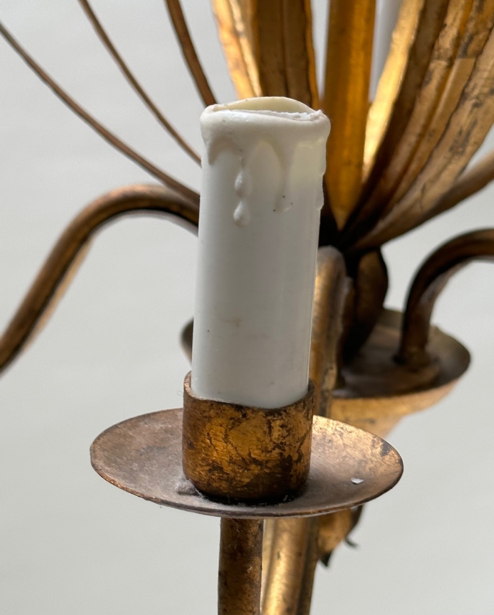 A French gilded metal chandelier featuring central vertical foliage leaves and three curved candle arms. View III