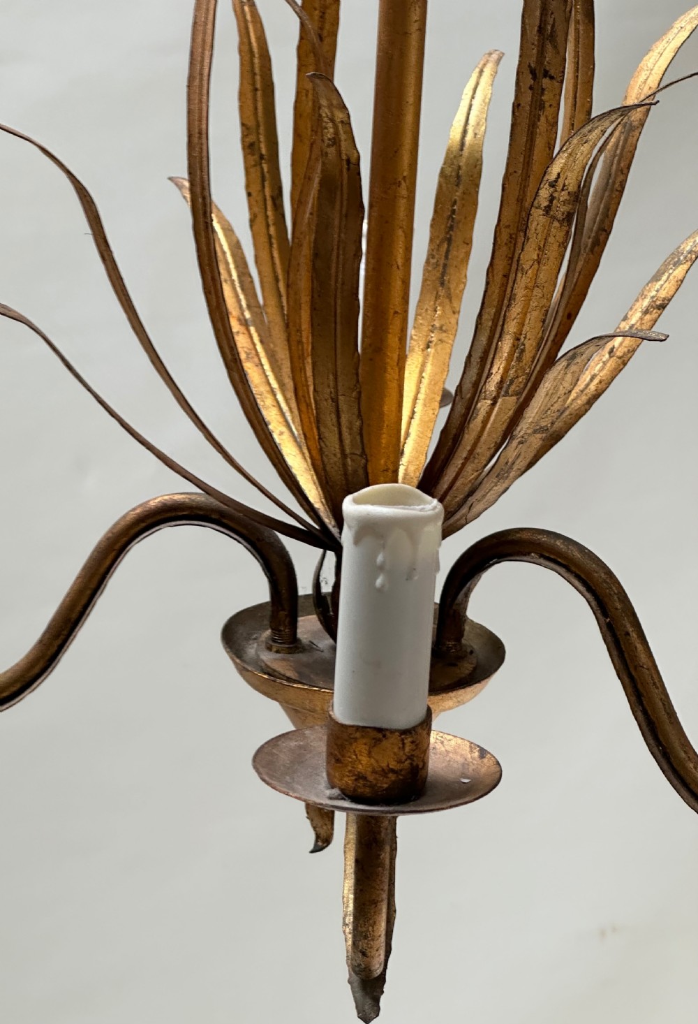 A French gilded metal chandelier featuring central vertical foliage leaves and three curved candle arms. View IV