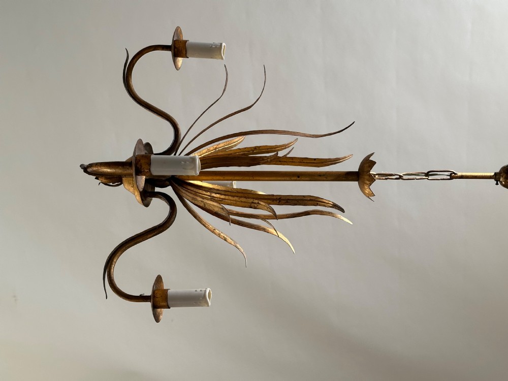 A French gilded metal chandelier featuring central vertical foliage leaves and three curved candle arms. View VII