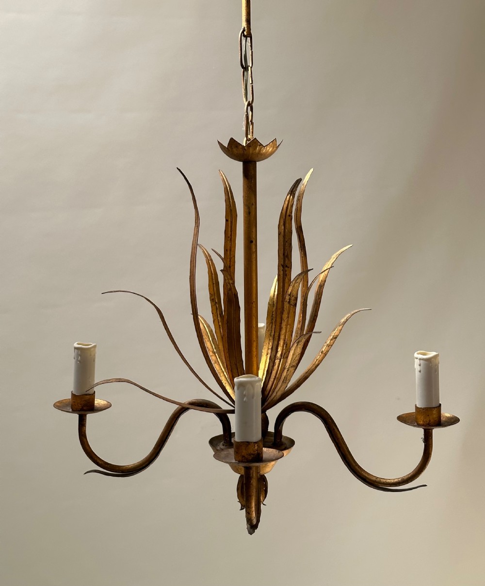 A French gilded metal chandelier featuring central vertical foliage leaves and three curved candle arms. View VIII