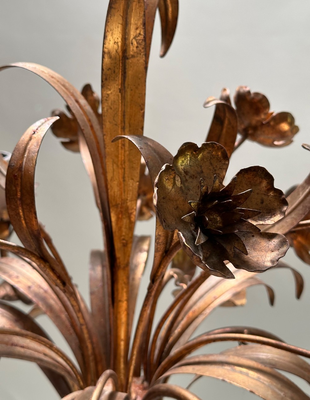 A French gilt metal multi-arm ceiling chandelier featuring sculptured flower petals, leaf motifs, and six candle-style light sockets. View III