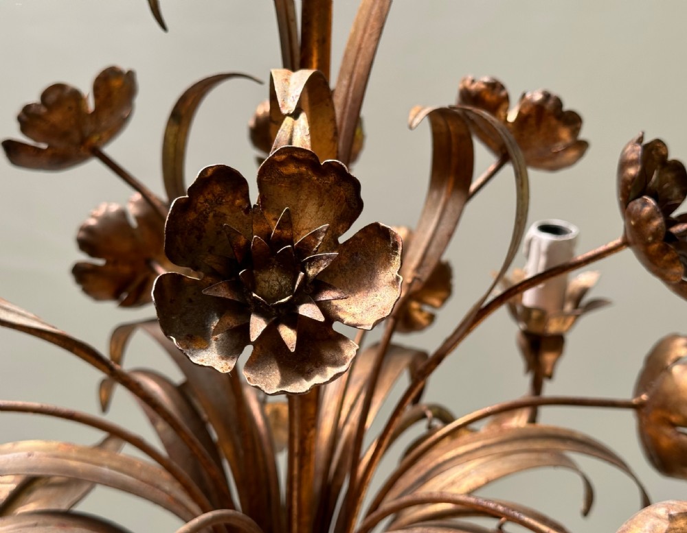 A French gilt metal multi-arm ceiling chandelier featuring sculptured flower petals, leaf motifs, and six candle-style light sockets. View IV