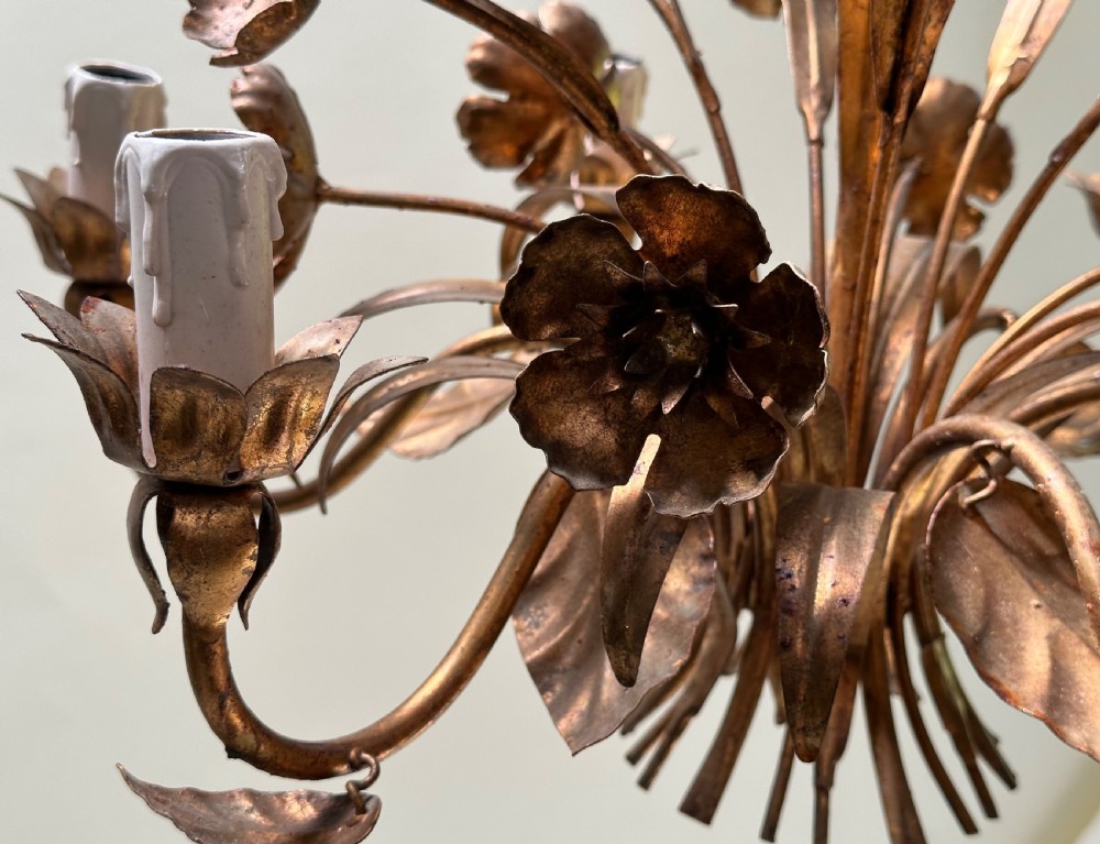 A French gilt metal multi-arm ceiling chandelier featuring sculptured flower petals, leaf motifs, and six candle-style light sockets. View V