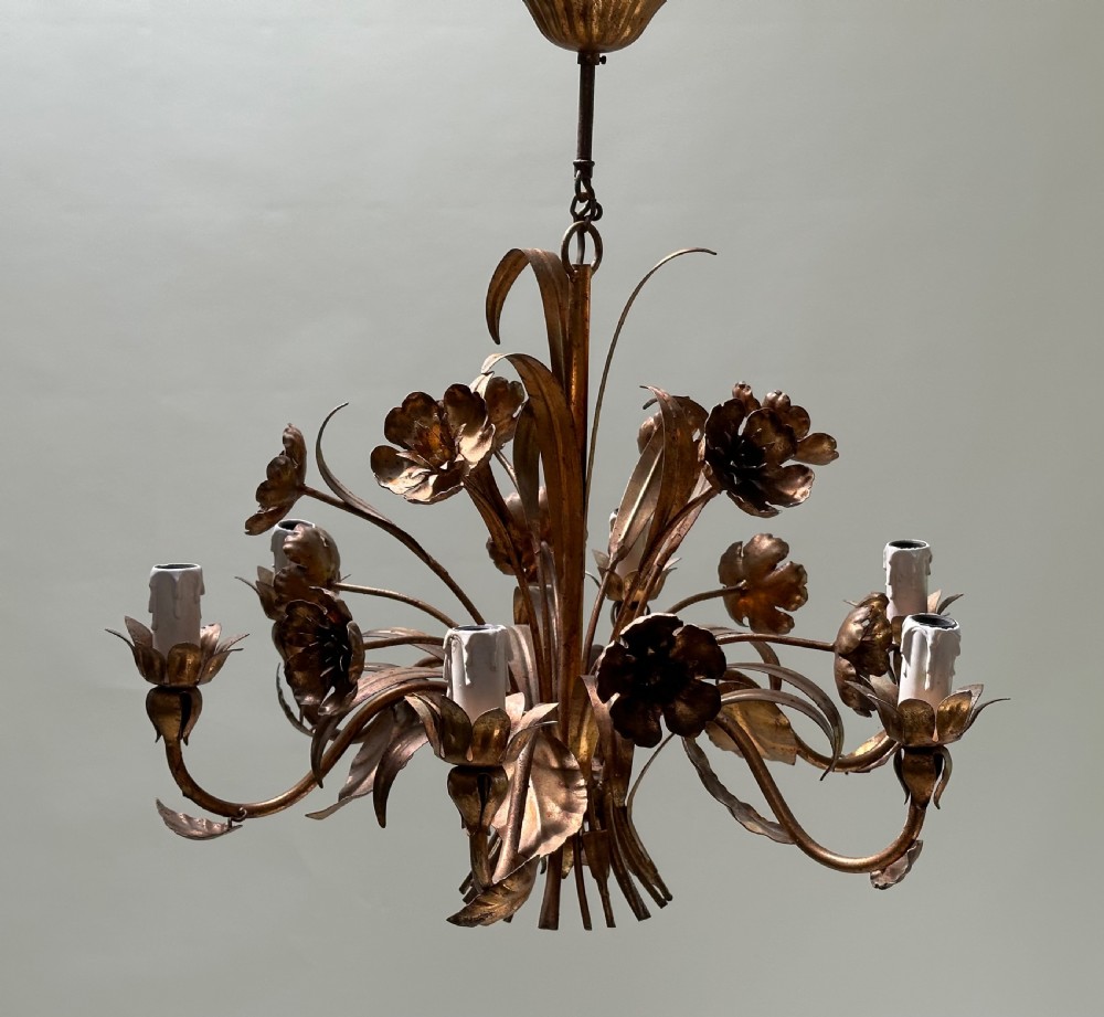 A French gilt metal multi-arm ceiling chandelier featuring sculptured flower petals, leaf motifs, and six candle-style light sockets. View VI