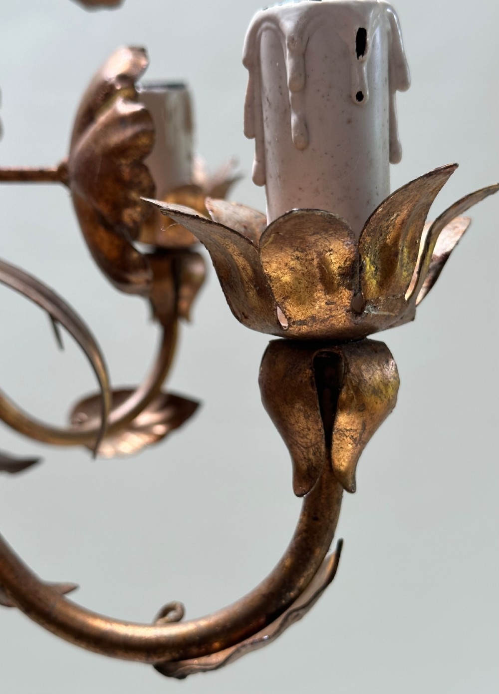 A French gilt metal multi-arm ceiling chandelier featuring sculptured flower petals, leaf motifs, and six candle-style light sockets. View VIII