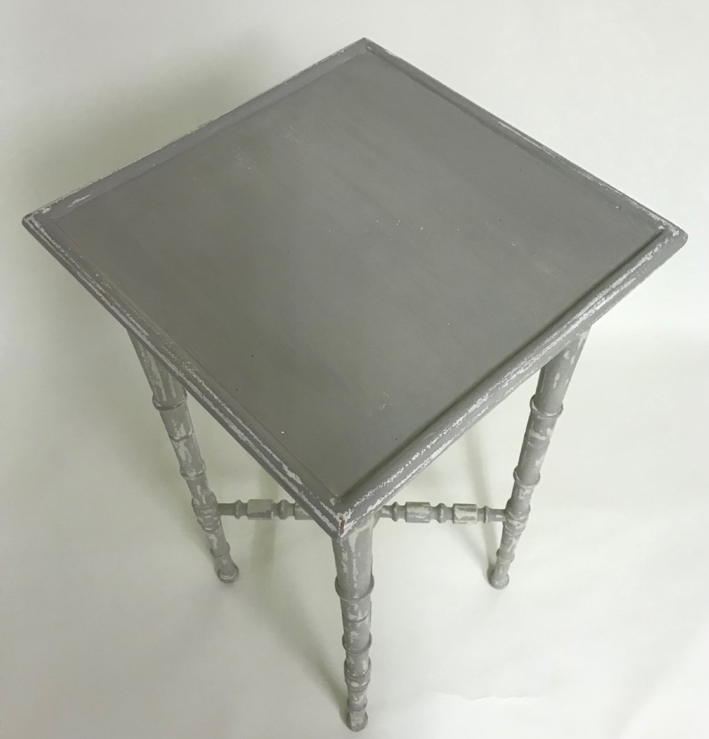 A tall light grey painted wooden side table featuring faux bamboo turned legs and a central X-frame stretcher. View II