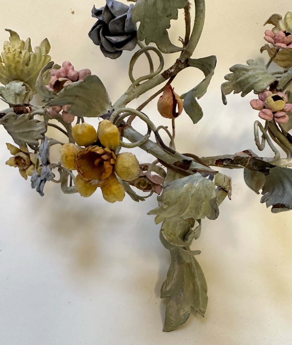 A pair of French floral wall sconces constructed from painted metal with branching foliate arms and colourful tulip-shaped sockets. View II