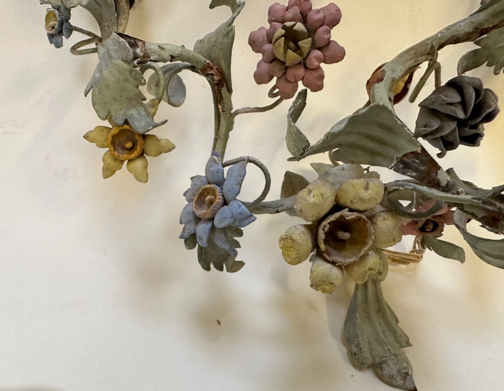 A pair of French floral wall sconces constructed from painted metal with branching foliate arms and colourful tulip-shaped sockets. View IV