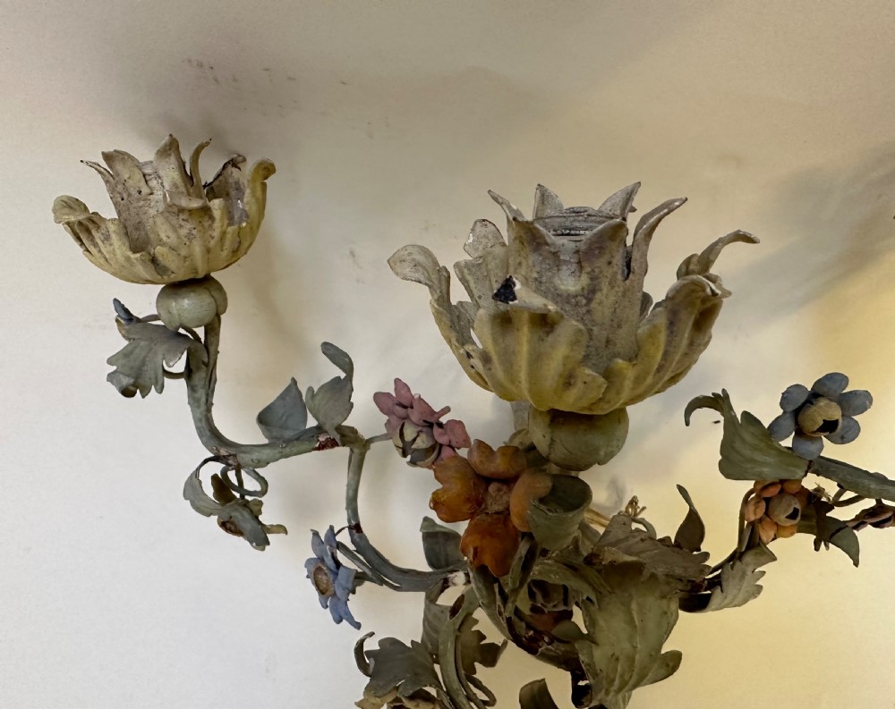 A pair of French floral wall sconces constructed from painted metal with branching foliate arms and colourful tulip-shaped sockets. View V