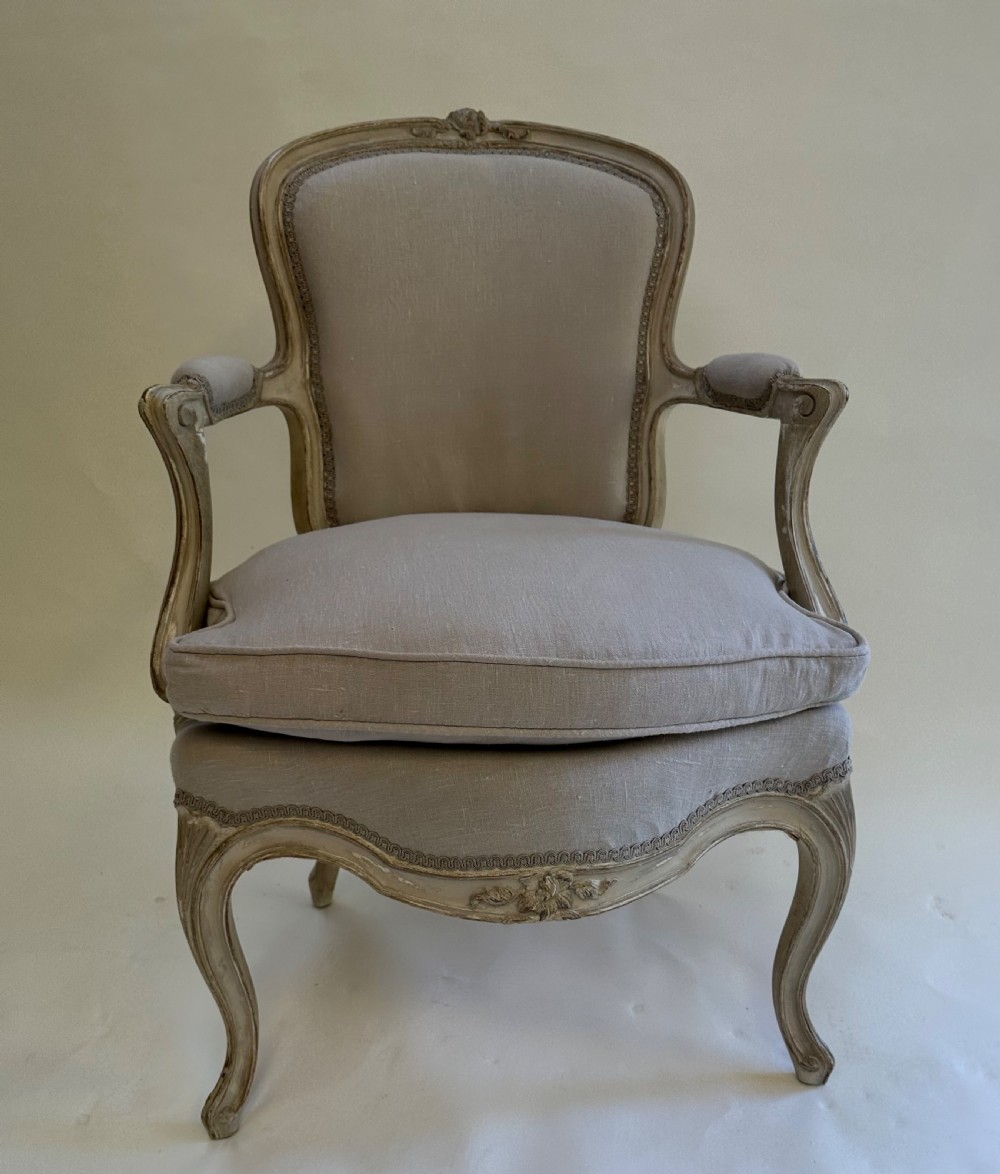 A pair of French Louis XV style open armchairs with grey painted carved wooden frames and neutral linen upholstery. View II