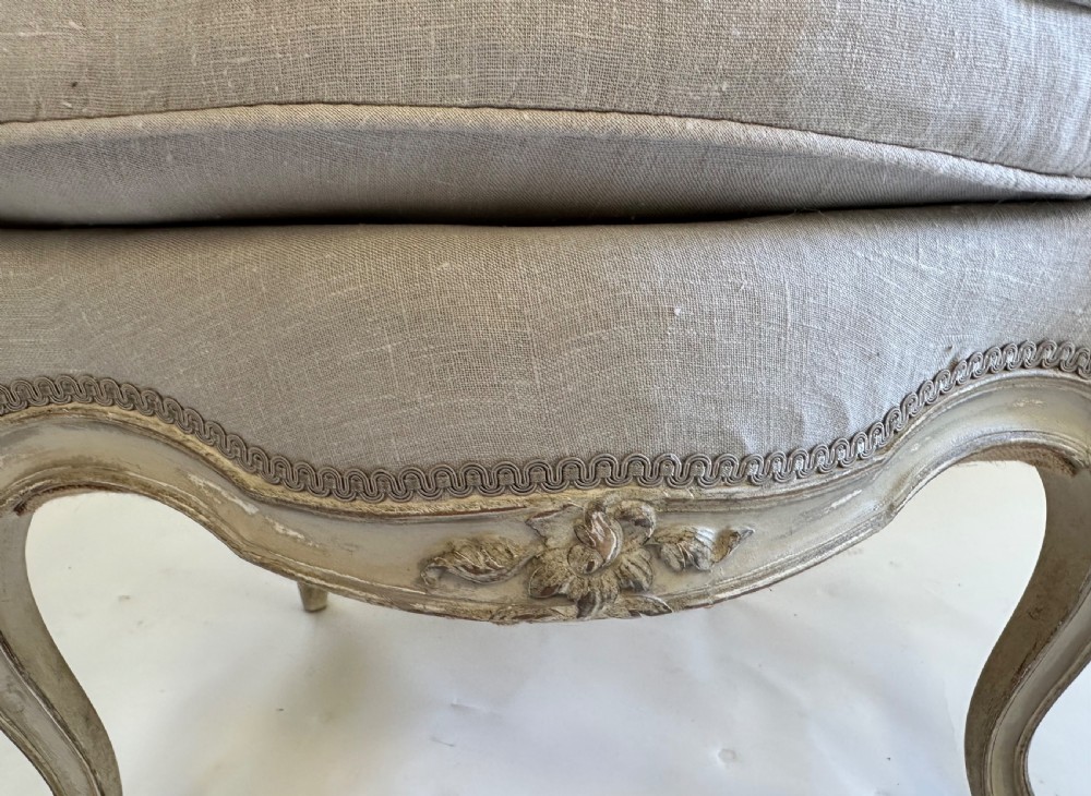 A pair of French Louis XV style open armchairs with grey painted carved wooden frames and neutral linen upholstery. View VII