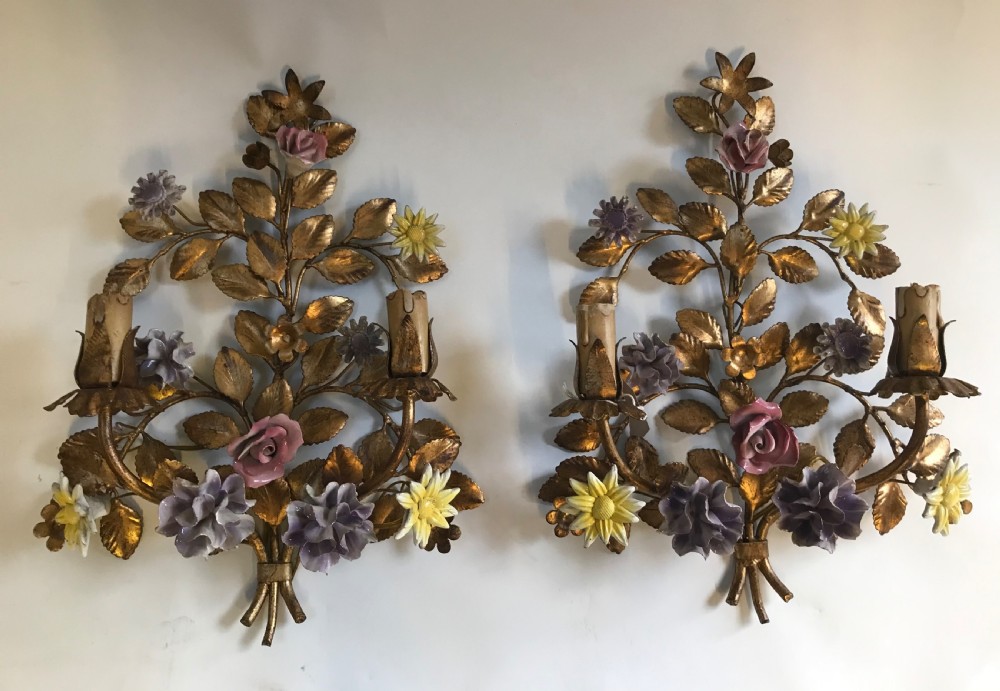 A pair of French gilt metal wall sconces shaped as botanical floral bouquets with colourful porcelain blossoms and two candle sleeves on each light fixture. View II