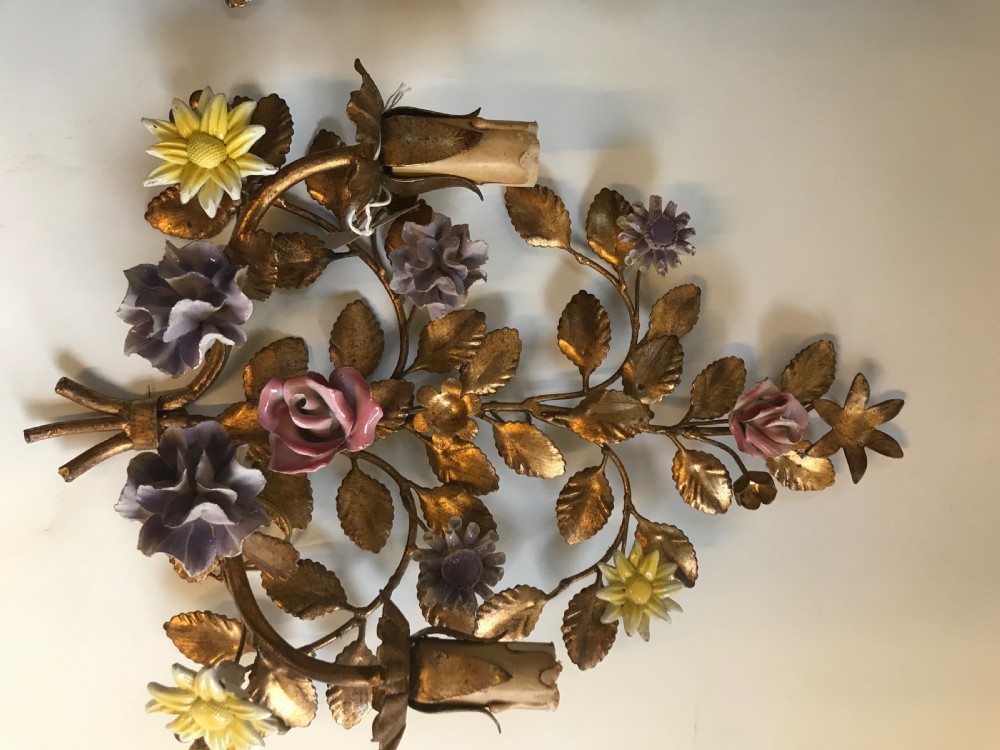 A pair of French gilt metal wall sconces shaped as botanical floral bouquets with colourful porcelain blossoms and two candle sleeves on each light fixture. View III