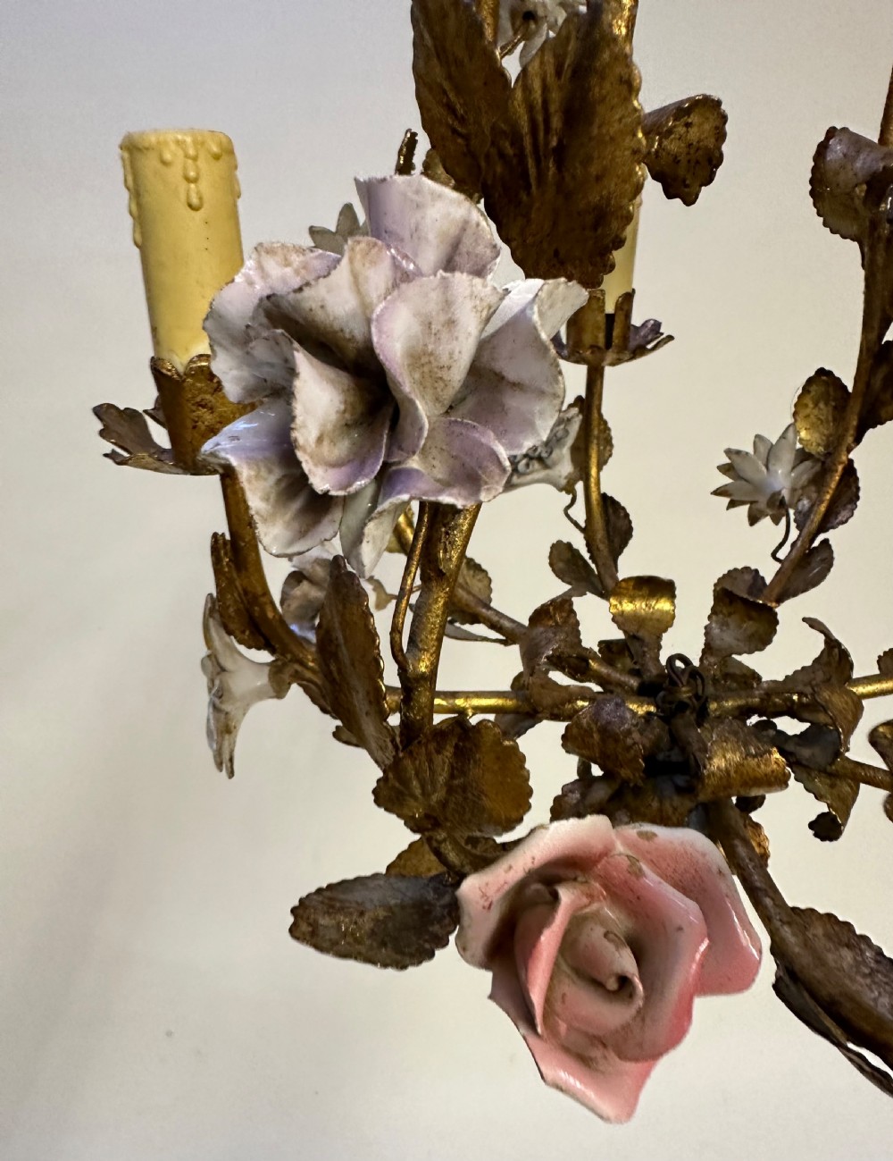 A French gilt metal cage chandelier decorated with multicoloured porcelain flowers and leaf motifs. View II