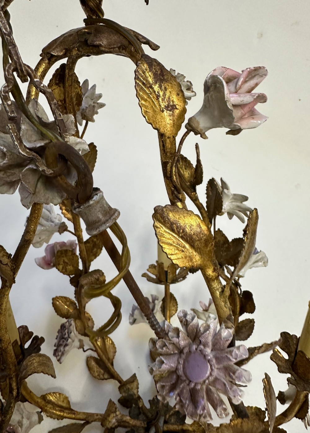 A French gilt metal cage chandelier decorated with multicoloured porcelain flowers and leaf motifs. View III