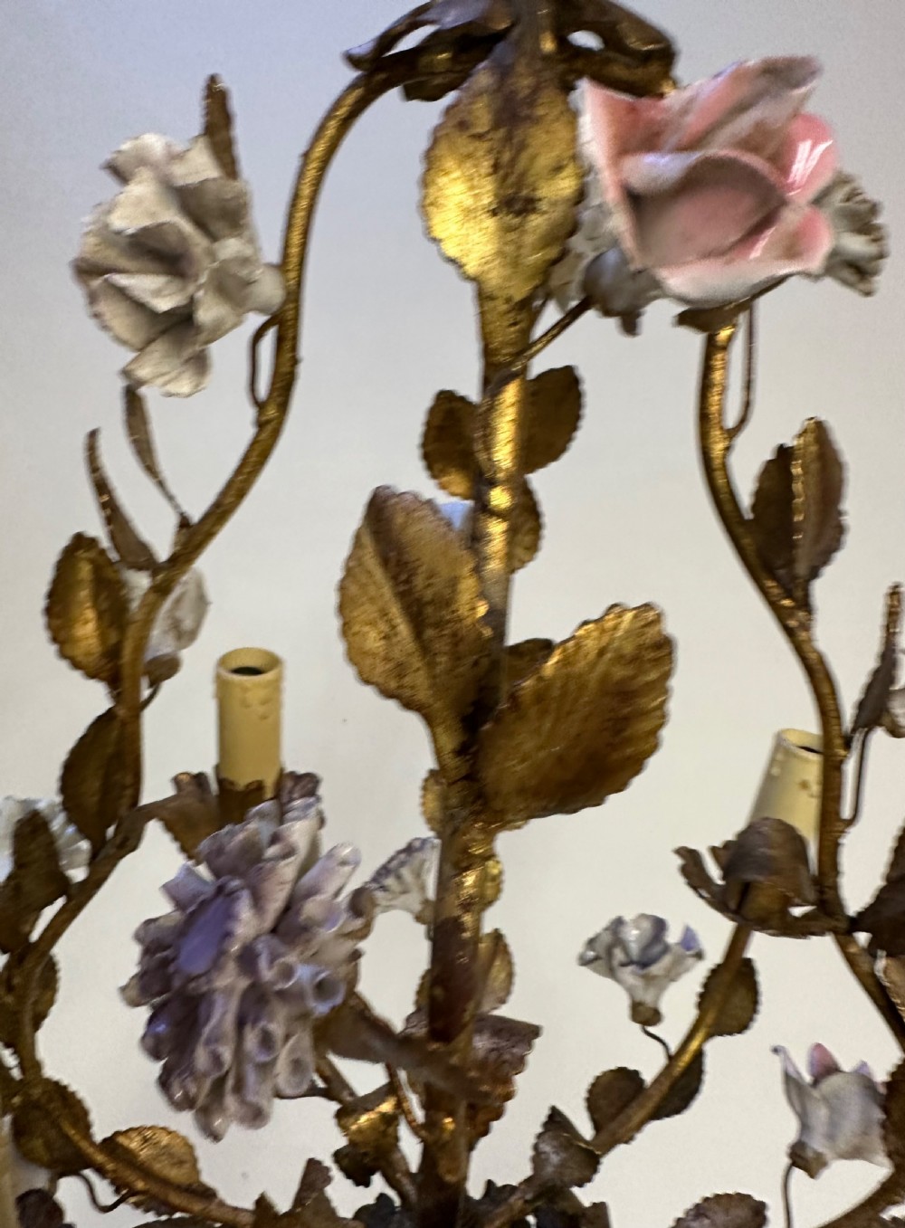 A French gilt metal cage chandelier decorated with multicoloured porcelain flowers and leaf motifs. View V