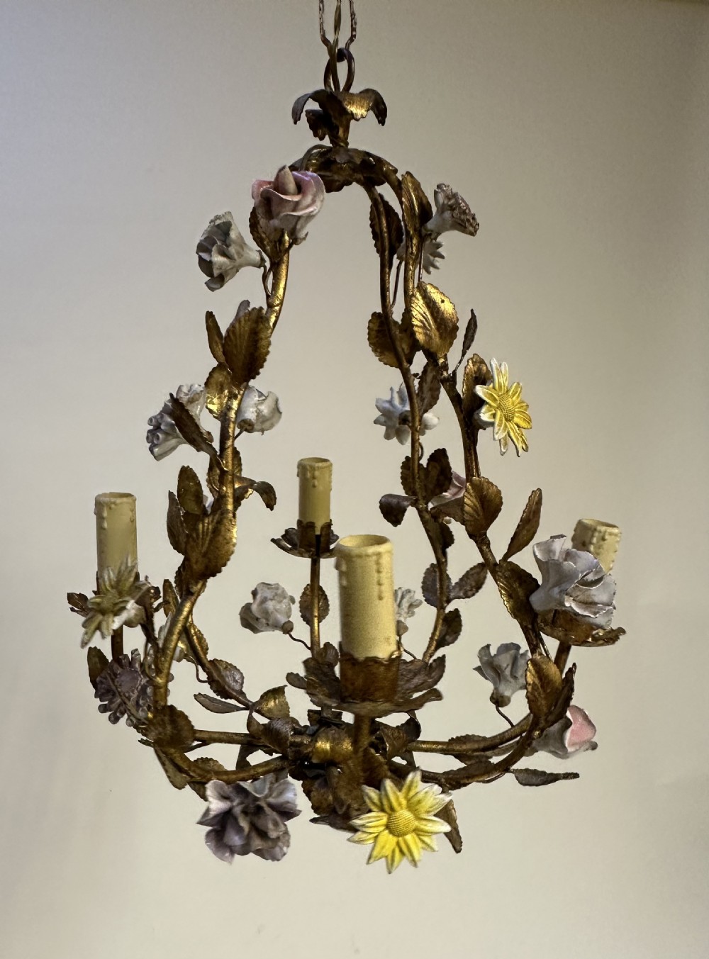 A French gilt metal cage chandelier decorated with multicoloured porcelain flowers and leaf motifs. View VI