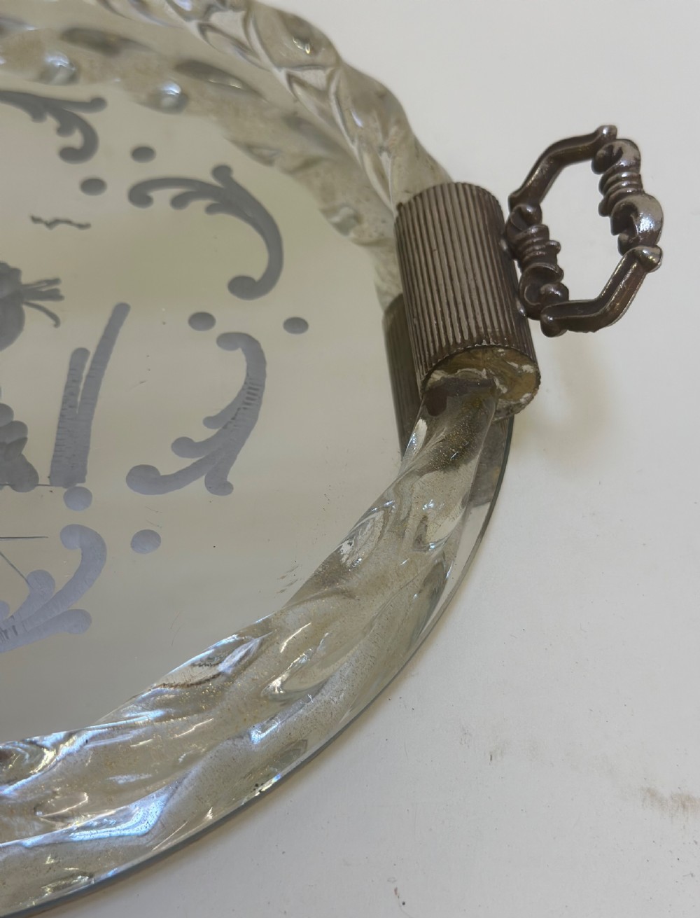 A circular Murano glass tray featuring a mirrored surface with an etched Venetian figure scene, framed by a twisted clear glass rim and two metal handles. View IV
