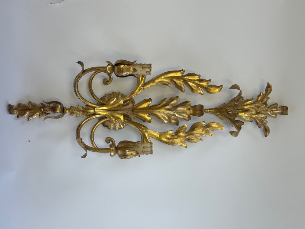 A set of four French gilded metal two-light wall sconces featuring scrolled acanthus leaf backplates and candle-style sconce arms. View II
