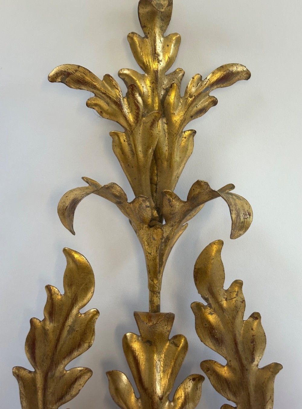 A set of four French gilded metal two-light wall sconces featuring scrolled acanthus leaf backplates and candle-style sconce arms. View IV