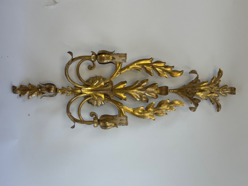 A set of four French gilded metal two-light wall sconces featuring scrolled acanthus leaf backplates and candle-style sconce arms. View VI