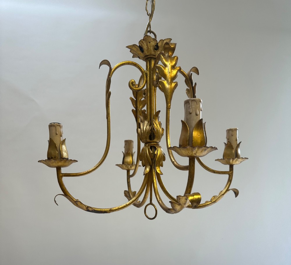A French gilded metal chandelier featuring four curved foliate arms, leaf motifs, central leaf decorations, and candle-style bulb holders. View III