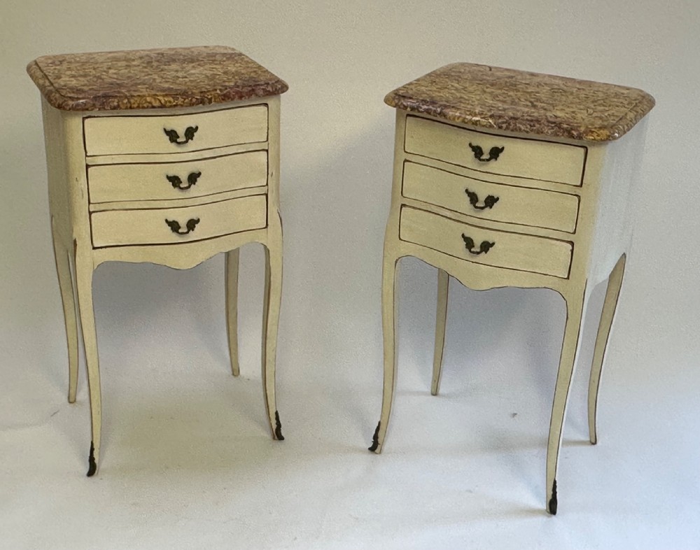 A pair of cream-painted French bedside tables featuring variegated marble tops, three drawers with brass pulls, and slender cabriole legs. View VII