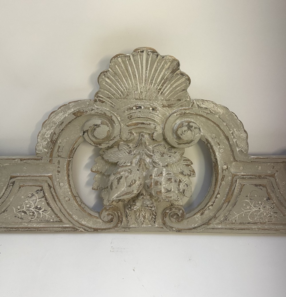 An antique French grey painted wooden pelmet featuring central hand-carved foliage and detailed scrollwork. View VII