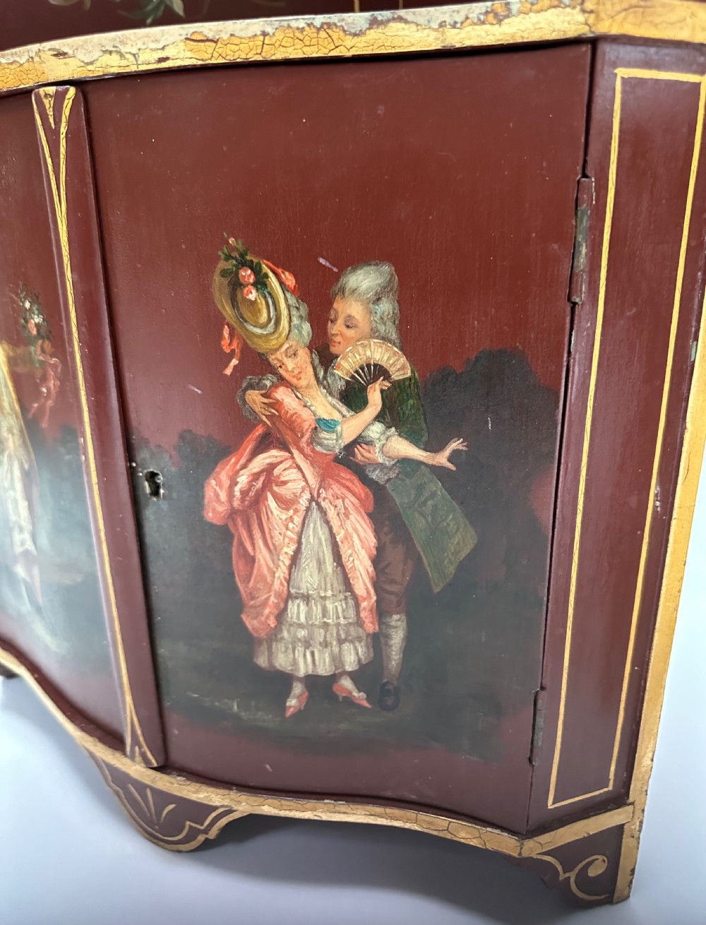 A matching pair of deep burgundy and gold painted Italian corner cupboards with upper open shelves and lower cabinet doors featuring hand-painted figures. View III