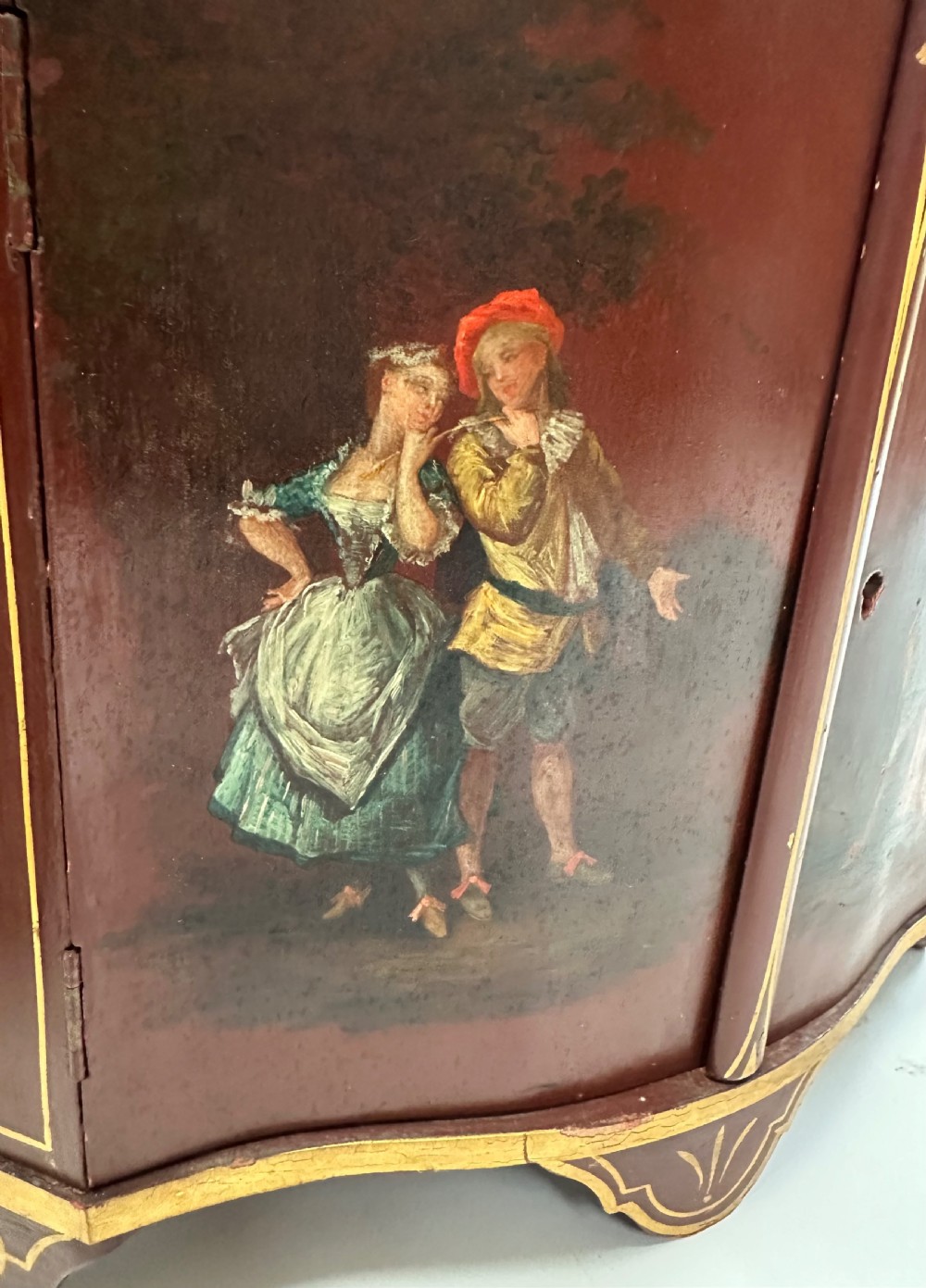 A matching pair of deep burgundy and gold painted Italian corner cupboards with upper open shelves and lower cabinet doors featuring hand-painted figures. View IV