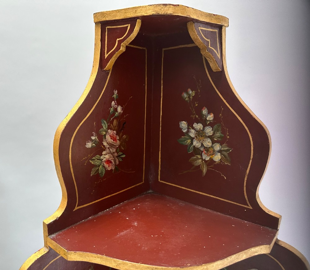 A matching pair of deep burgundy and gold painted Italian corner cupboards with upper open shelves and lower cabinet doors featuring hand-painted figures. View VIII