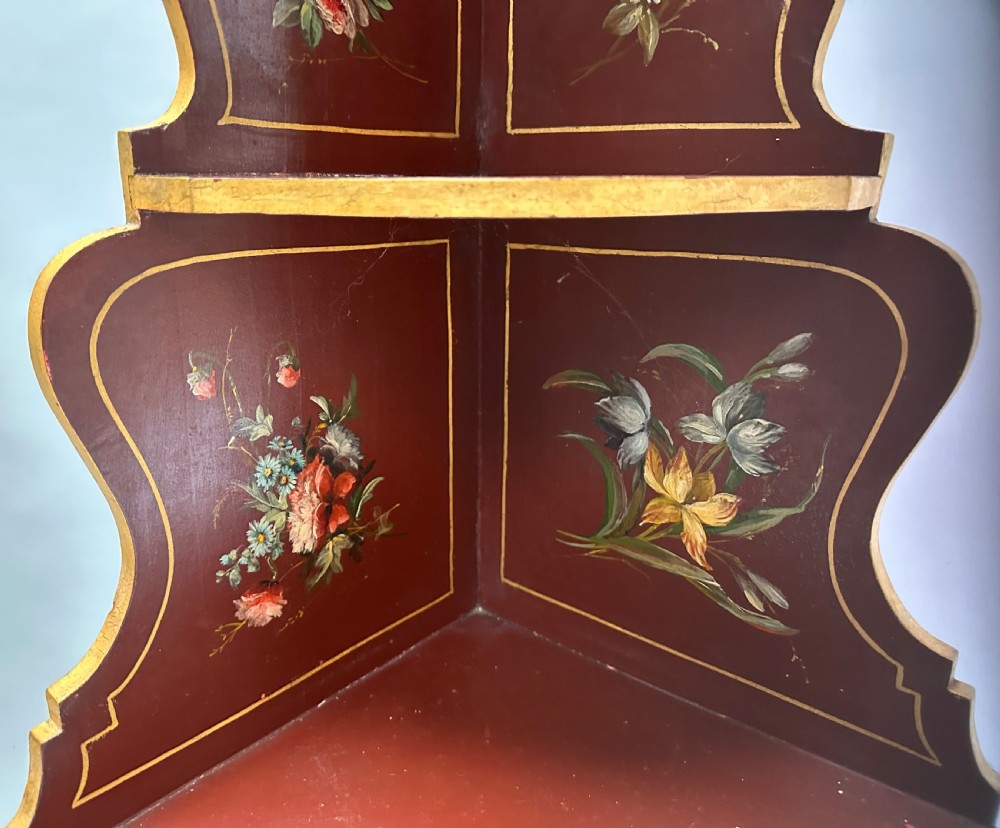 A matching pair of deep burgundy and gold painted Italian corner cupboards with upper open shelves and lower cabinet doors featuring hand-painted figures. View XII