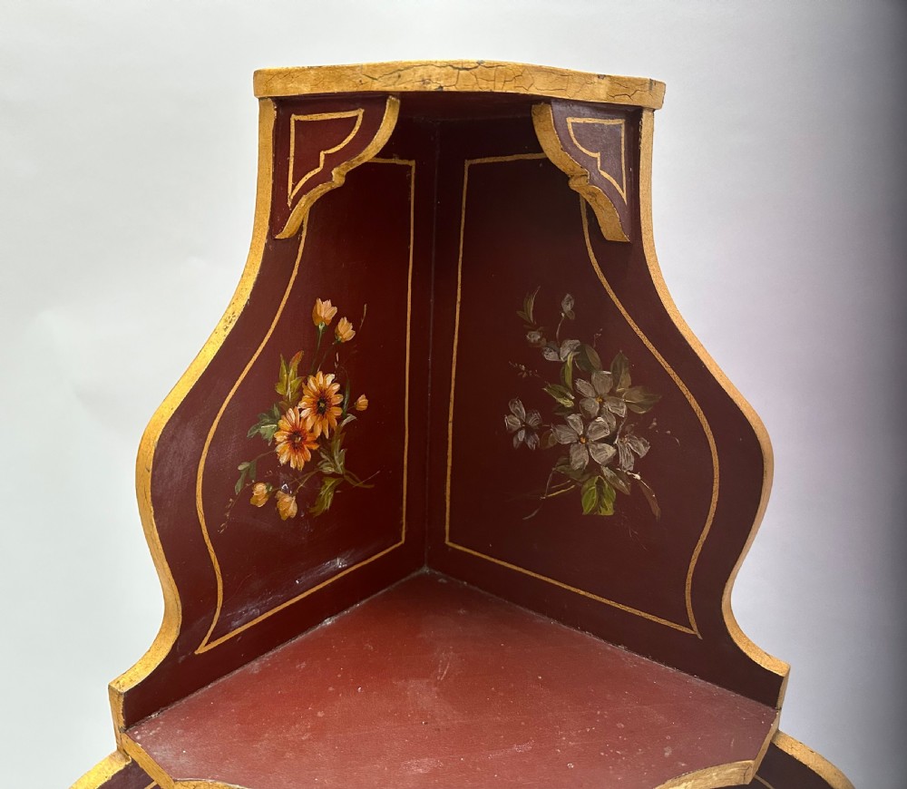 A matching pair of deep burgundy and gold painted Italian corner cupboards with upper open shelves and lower cabinet doors featuring hand-painted figures. View XIII