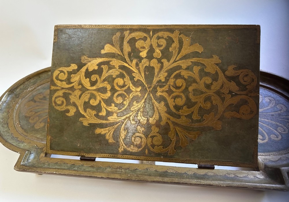 An antique Florentine painted and giltwood tabletop book stand with an open book resting on its angled surface. View III