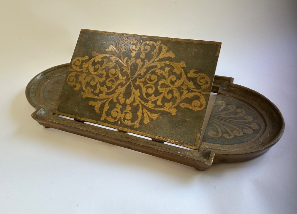 An antique Florentine painted and giltwood tabletop book stand with an open book resting on its angled surface. View IX