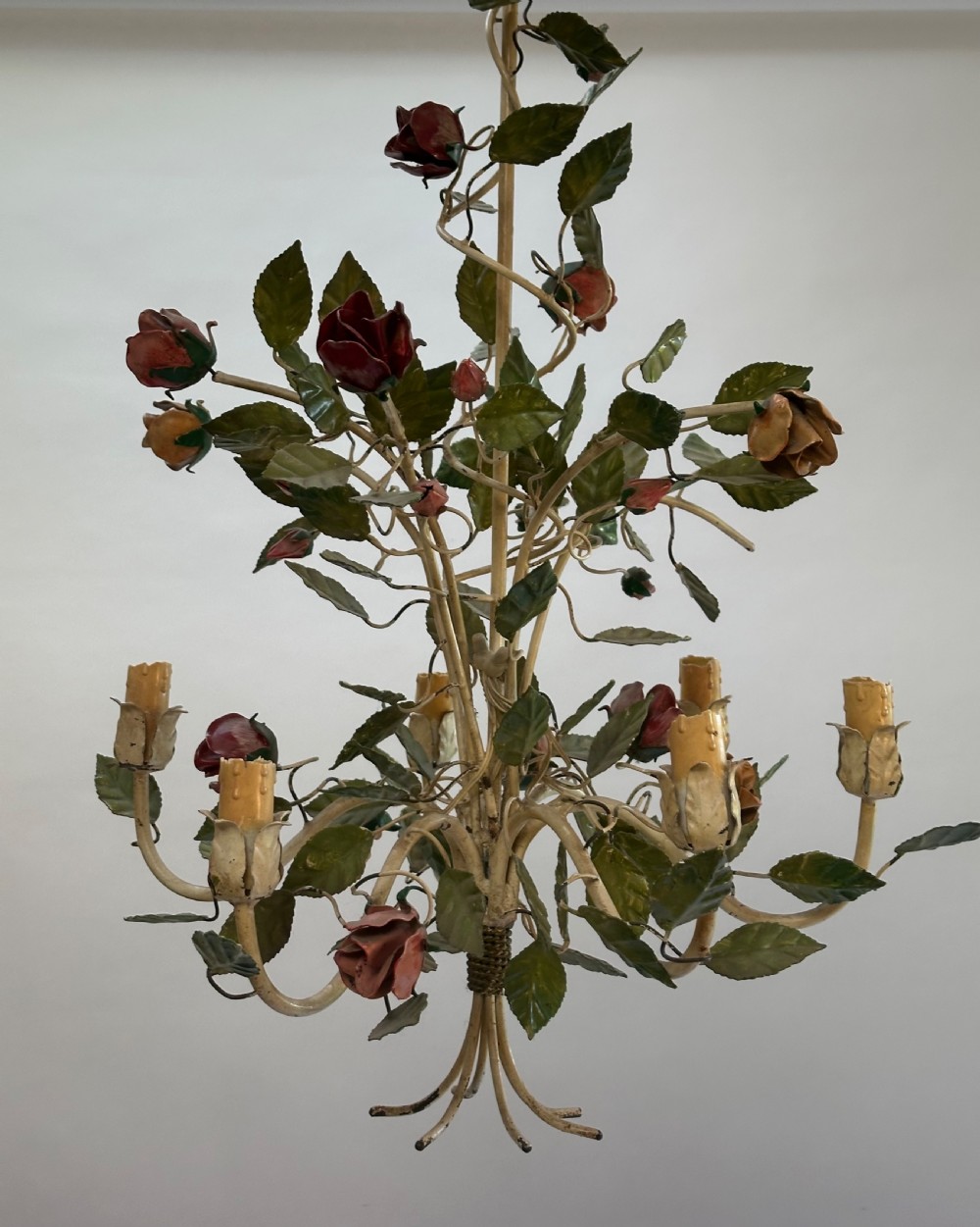A French painted metal chandelier featuring dark green leaves, red rose blossoms, and cream candle-style lamp holders. View II