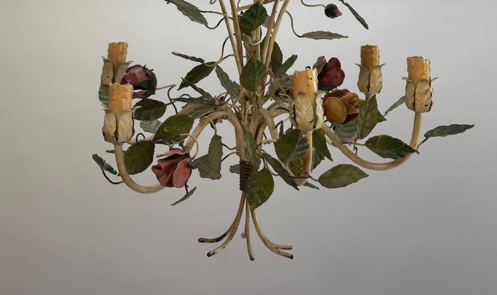 A French painted metal chandelier featuring dark green leaves, red rose blossoms, and cream candle-style lamp holders. View V