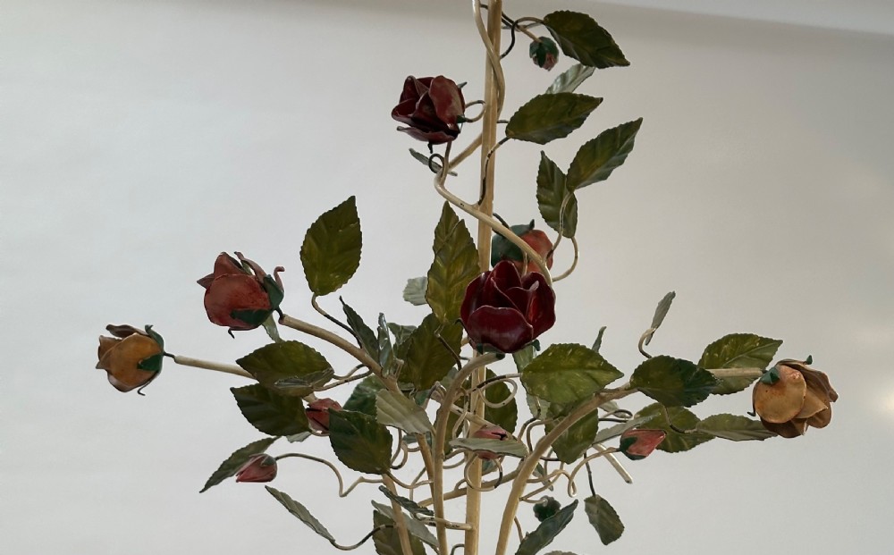 A French painted metal chandelier featuring dark green leaves, red rose blossoms, and cream candle-style lamp holders. View VI