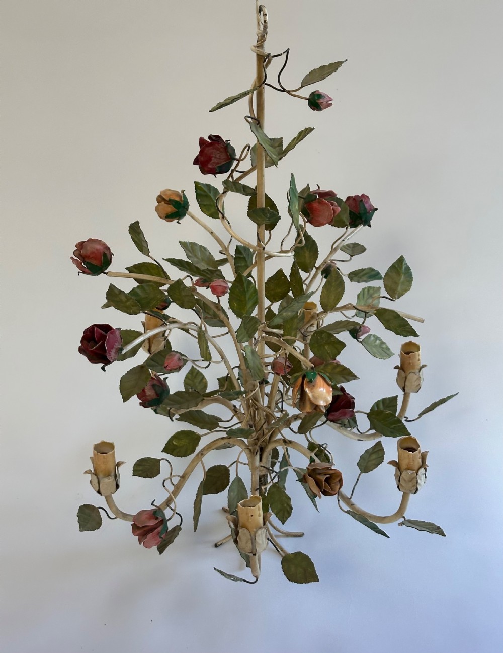 A French painted metal chandelier featuring dark green leaves, red rose blossoms, and cream candle-style lamp holders. View VII