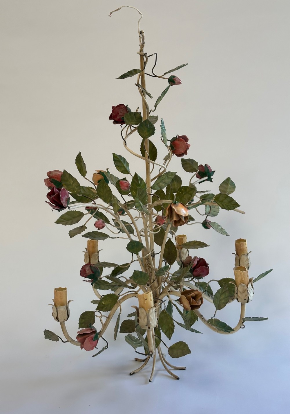 A French painted metal chandelier featuring dark green leaves, red rose blossoms, and cream candle-style lamp holders. View VIII