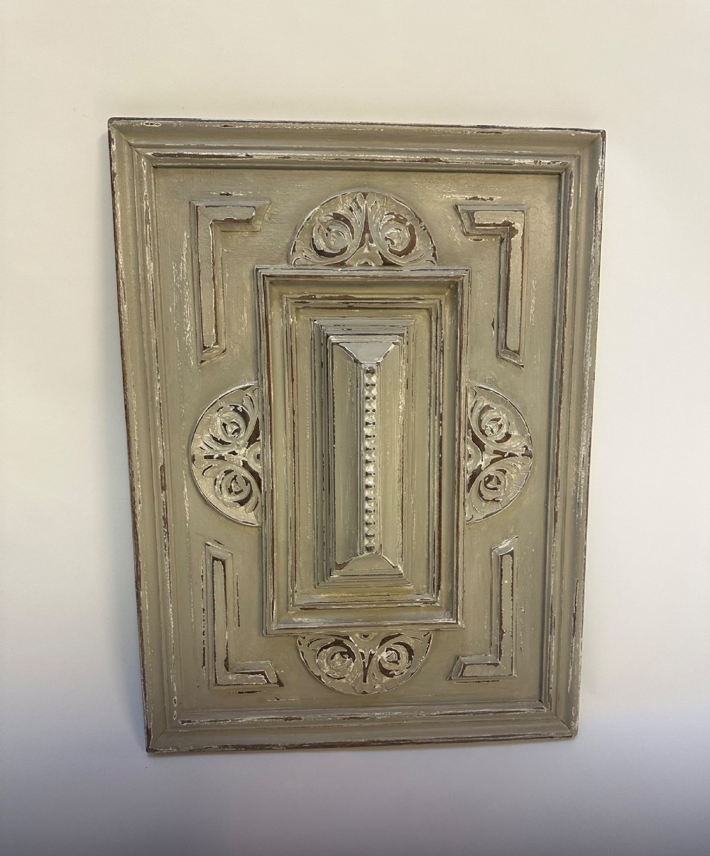 A pair of rectangular French hand-carved wooden panels featuring raised geometric mouldings, relief scrolls, and a distressed grey painted finish. View IV