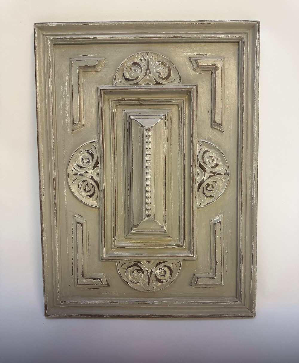 A pair of rectangular French hand-carved wooden panels featuring raised geometric mouldings, relief scrolls, and a distressed grey painted finish. View VI